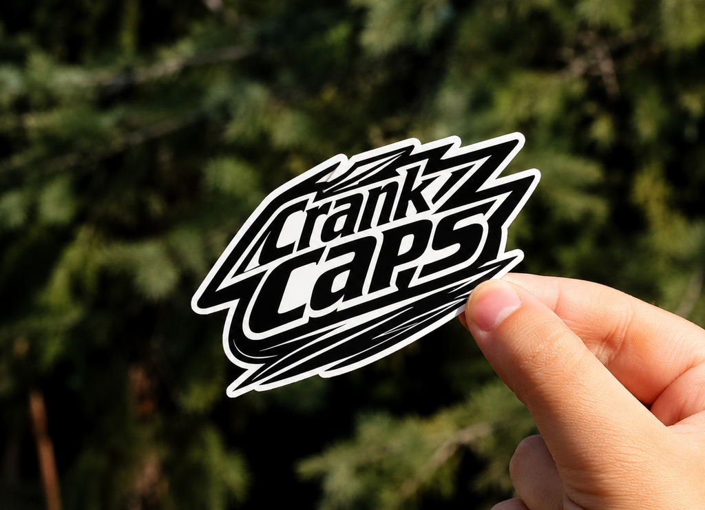 Shred MTB Sticker By Crank Caps on a blurred outdoor background
