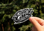 Shred MTB Sticker By Crank Caps on a blurred outdoor background