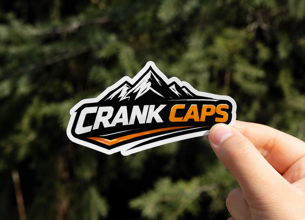 Summit Sticker – CrankCaps MTB Stickers on a blurred outdoor background.